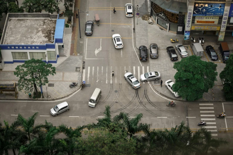 an overhead view of a street with several vehicles