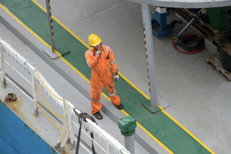 an industrial worker on a ferry with his head down