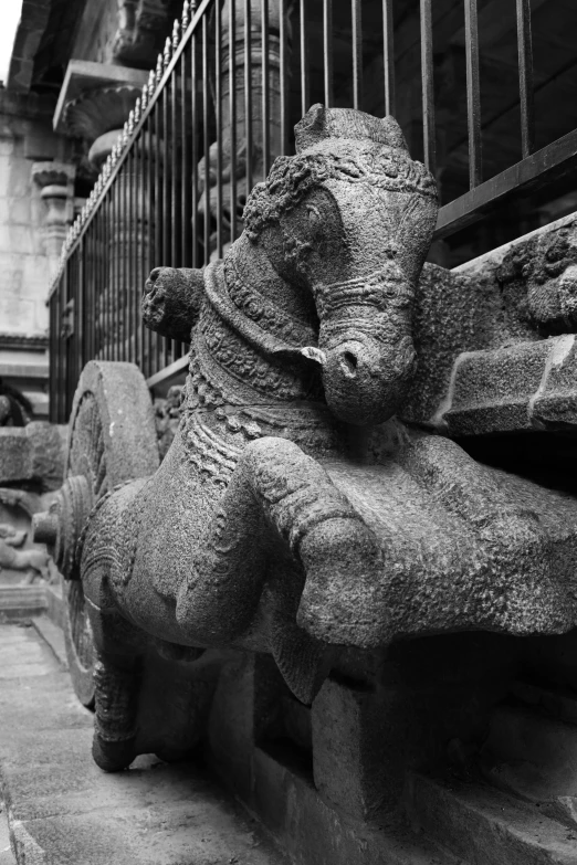 some old cement sculptures are sitting on the curb