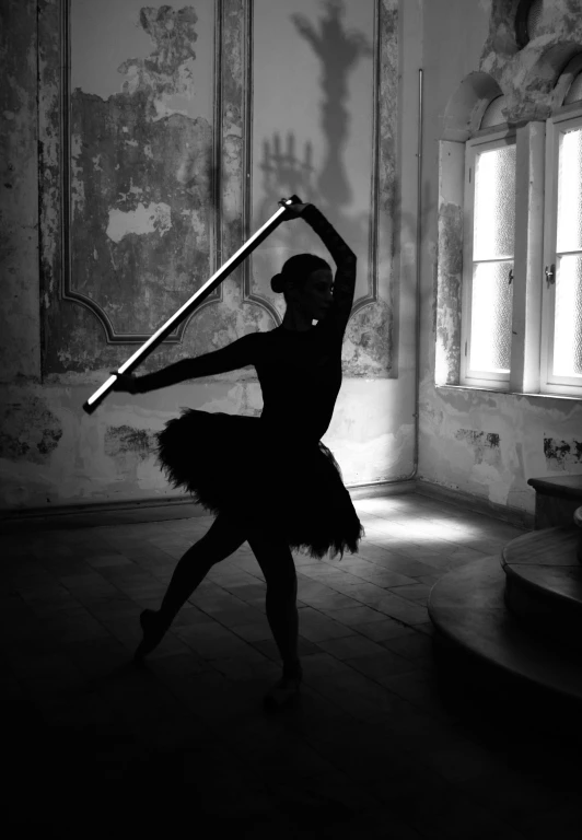 a woman in a black and white po holding up a large sword