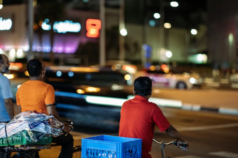 two men are riding a cart on the street