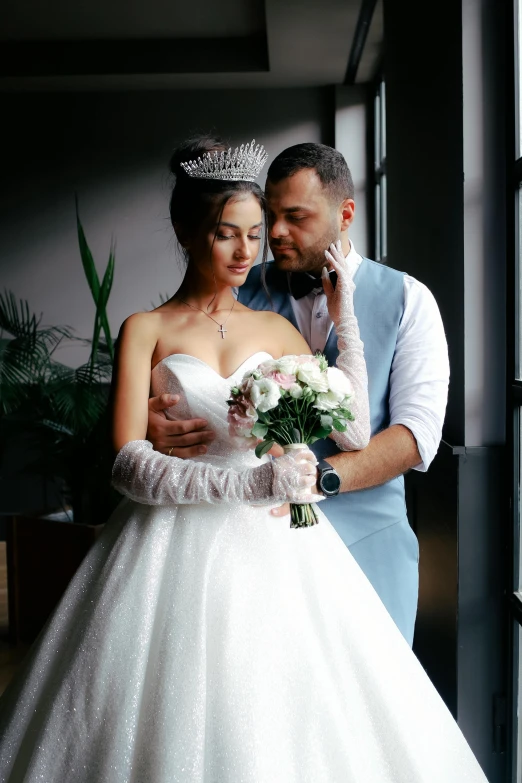 a man and woman in wedding outfits are looking into each others eyes