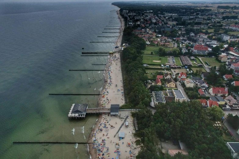 an aerial view of the beach with several boats in it