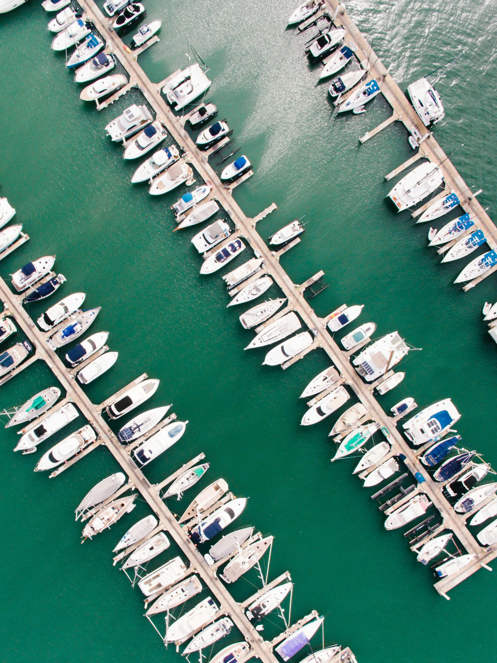 several boats are docked in a small body of water