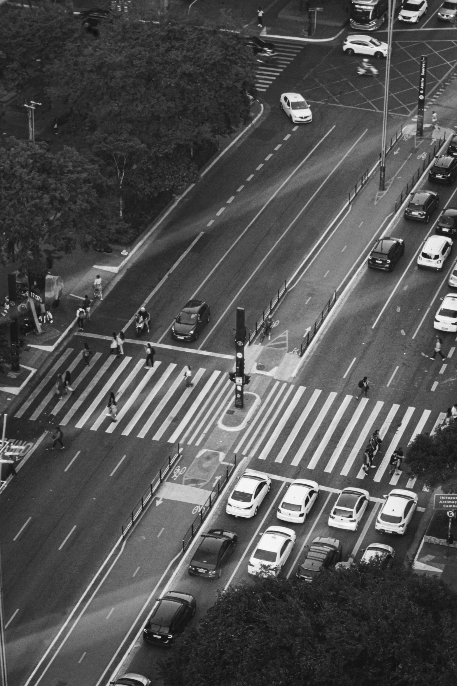 an aerial view of an intersection with traffic, trucks and traffic lights