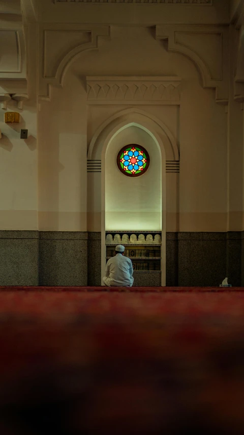 a man standing next to a cathedral window