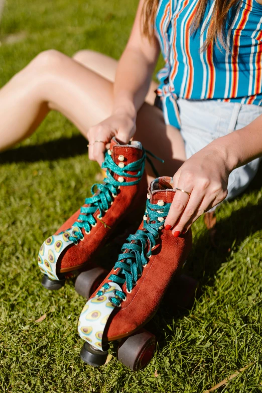 a woman tying her red and blue roller blades