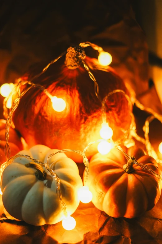 a bunch of small pumpkins sitting on a table