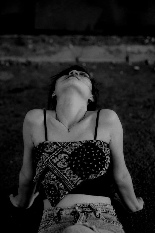 black and white pograph of a woman lying in grass