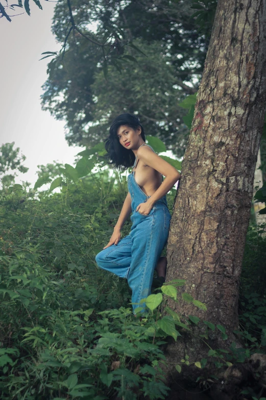 a woman is posing in a forest for a picture