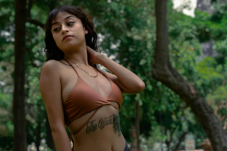 a woman with a tattoo on her chest posing