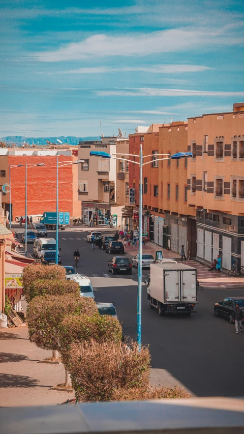 an urban city street is very quiet with cars parked on the side