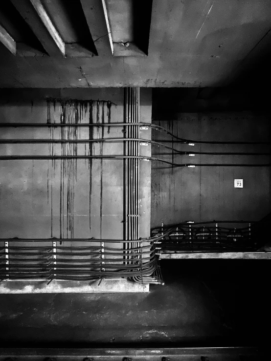 black and white pograph of metal railings in the middle of a parking garage