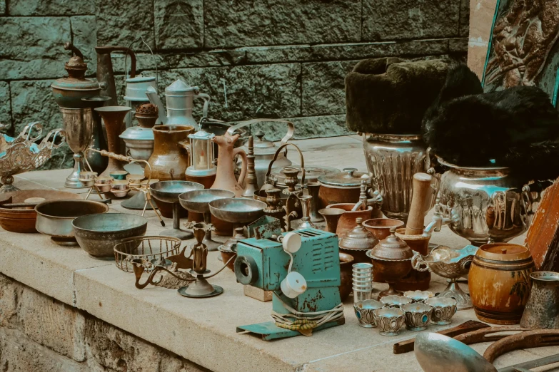 many jars are on a counter with various objects