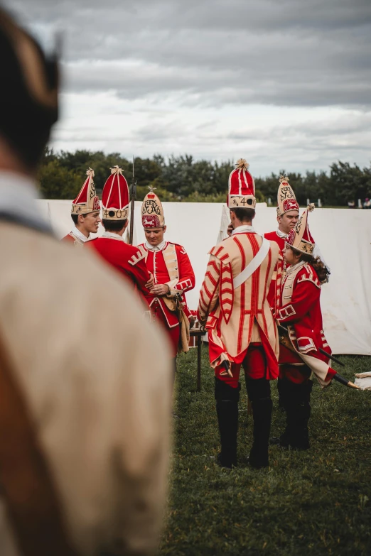 a band standing on top of a lush green field