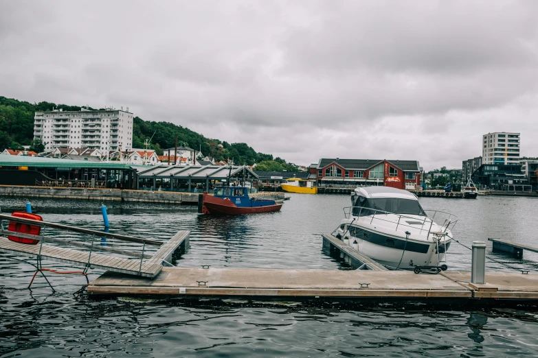 boats are docked in the water near a city