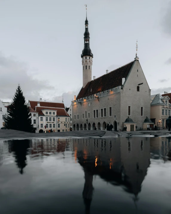 an old building with a reflection in water