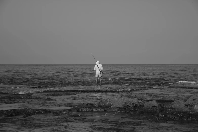 a person standing on rocks near water