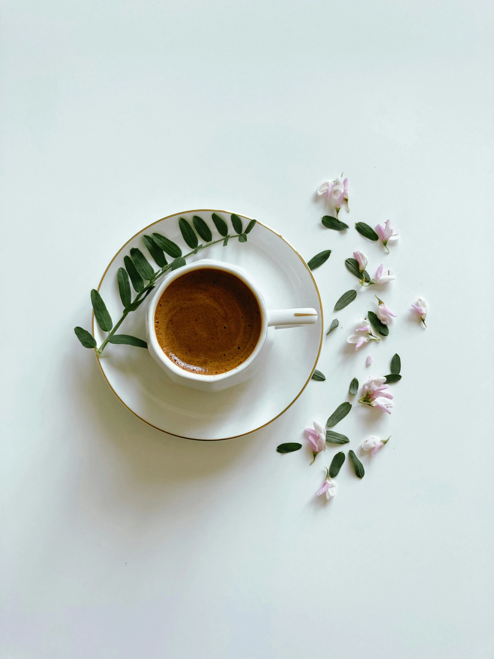 an image of cup coffee with flowers on it