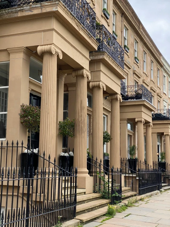 some very long pretty brown buildings with windows