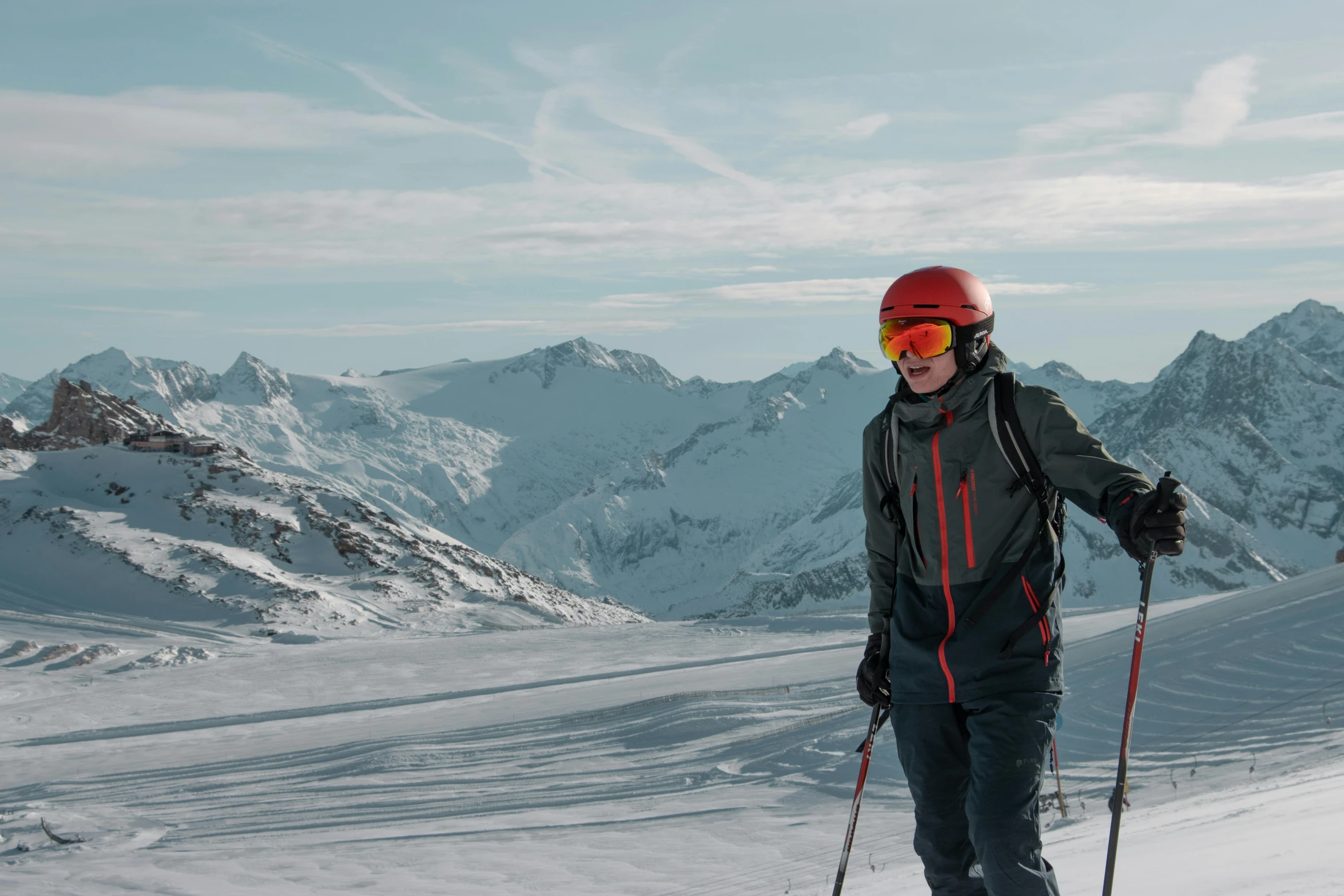 the person wearing red is posing with skis