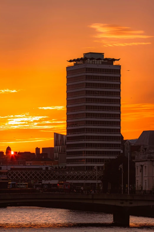 a sunset over a city with tall buildings