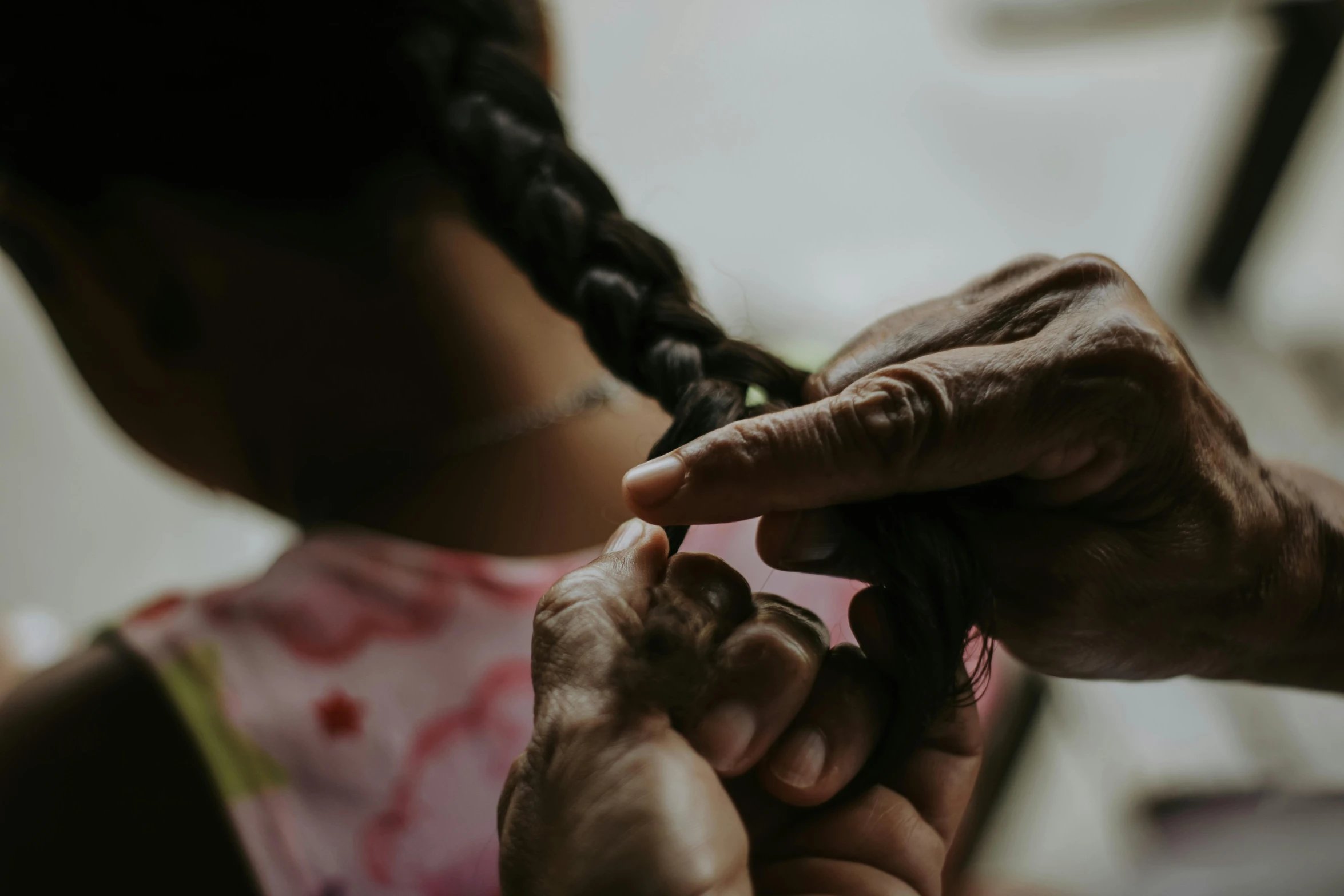 a woman is giving a little girl hair