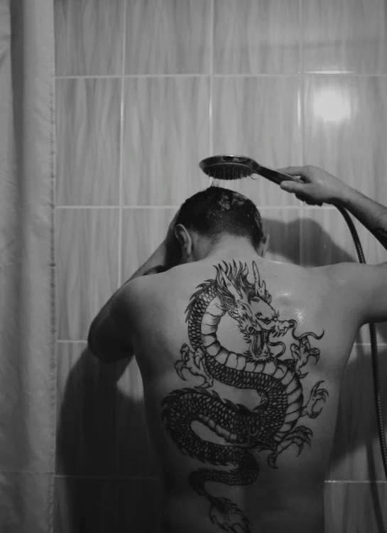 a man that has a tattoo on his back