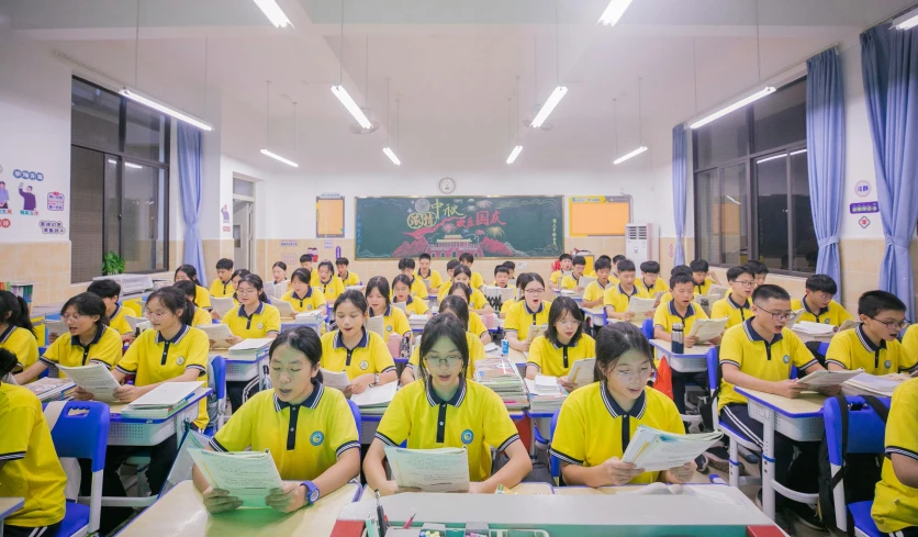 several children are in desks in a classroom