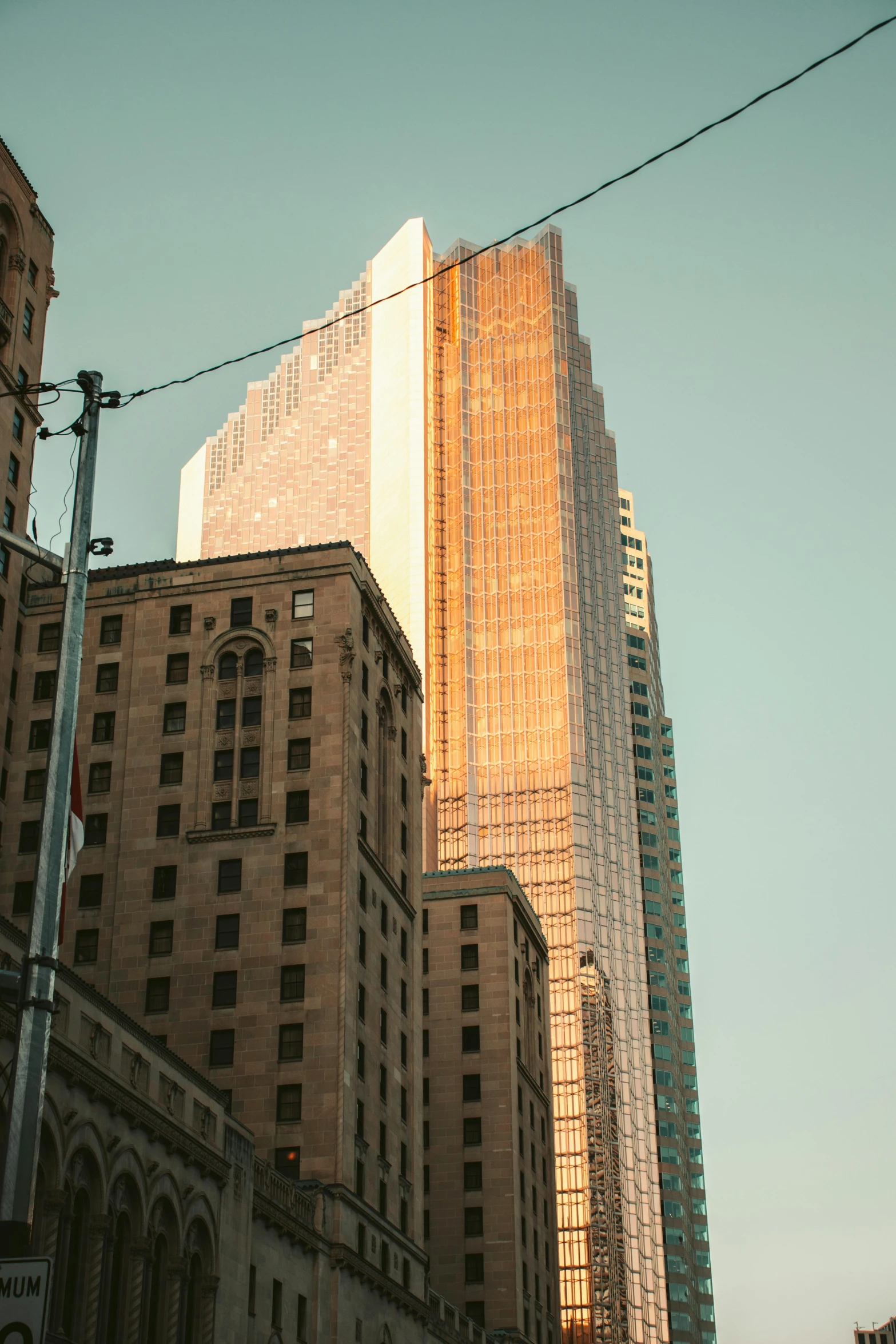 a group of large skyscrs stand out against a blue sky