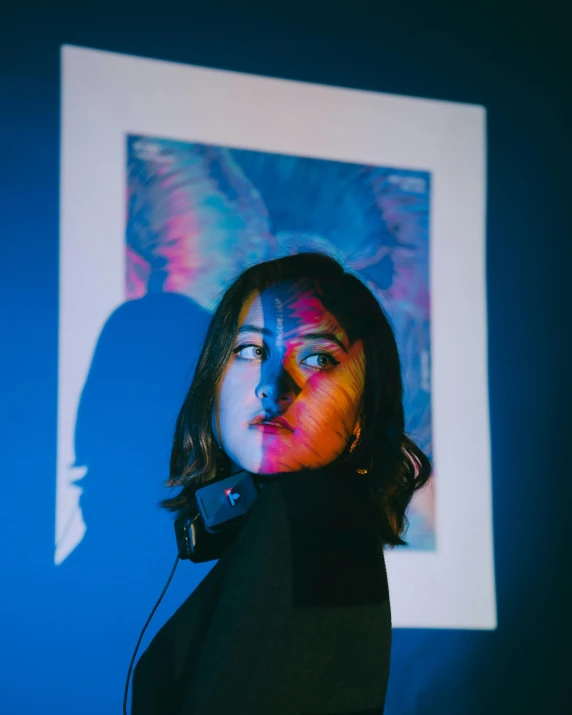 a woman is standing in front of a painting