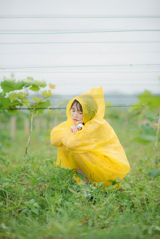 little girl in a yellow jacket in the field