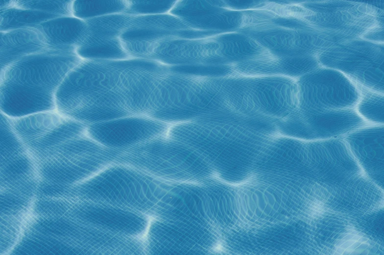 a pool with water ripples and light reflecting on it