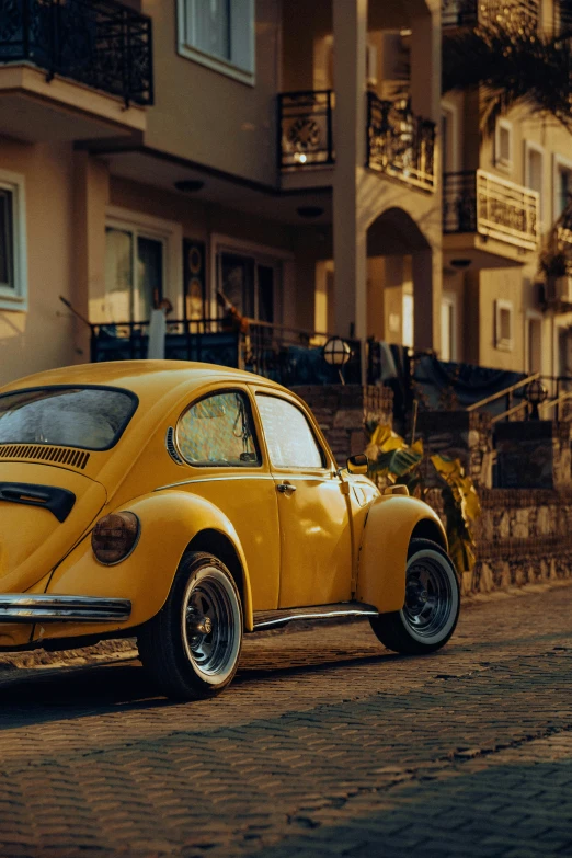 the yellow car is parked near some buildings