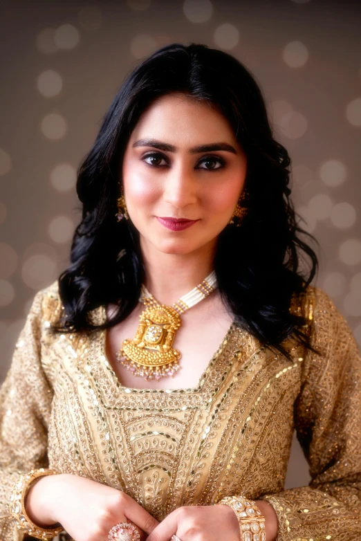woman wearing traditional indian jewellery and gold outfit