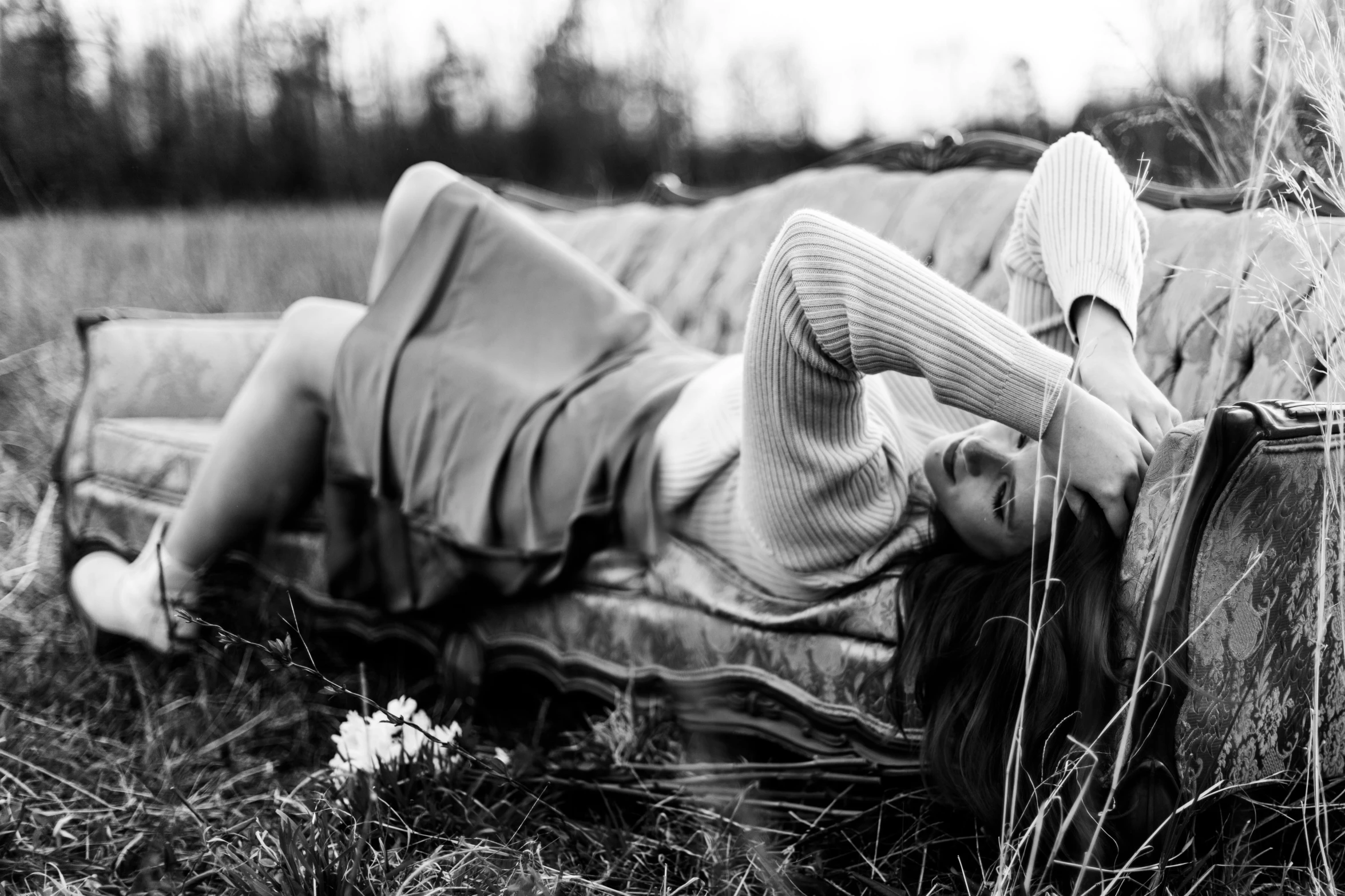 a woman that is laying down in the grass