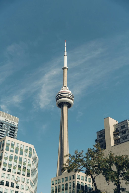 a tall tower rises above some buildings