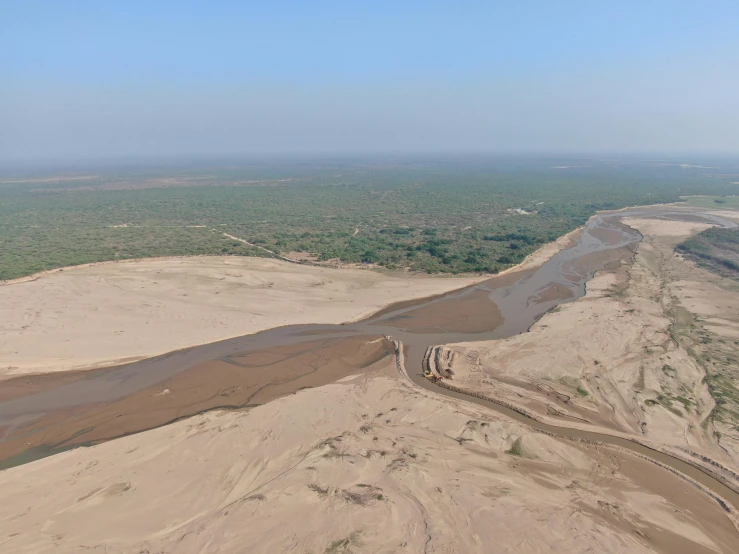 an airplane flying over an area with some water