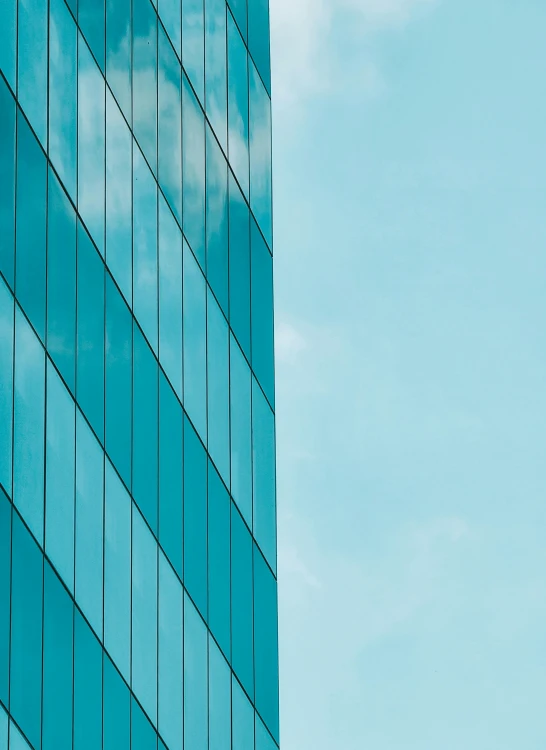 a very tall building sitting next to a bright blue sky