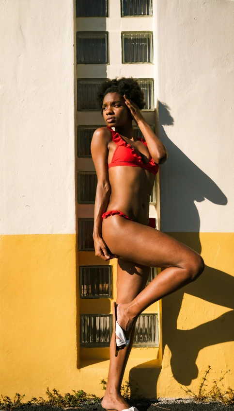 a women posing in a bikini and looking into the camera