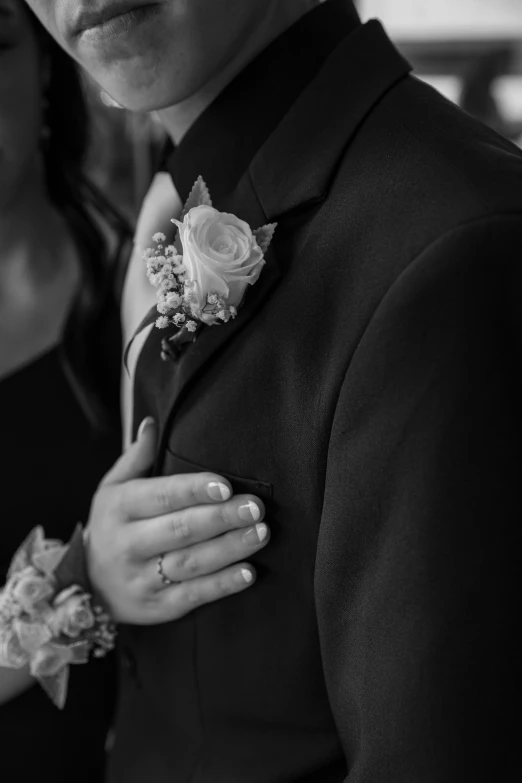 a man in a suit and flowered boutonniere