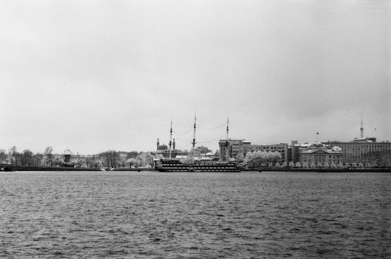 the river is full of ships and buildings