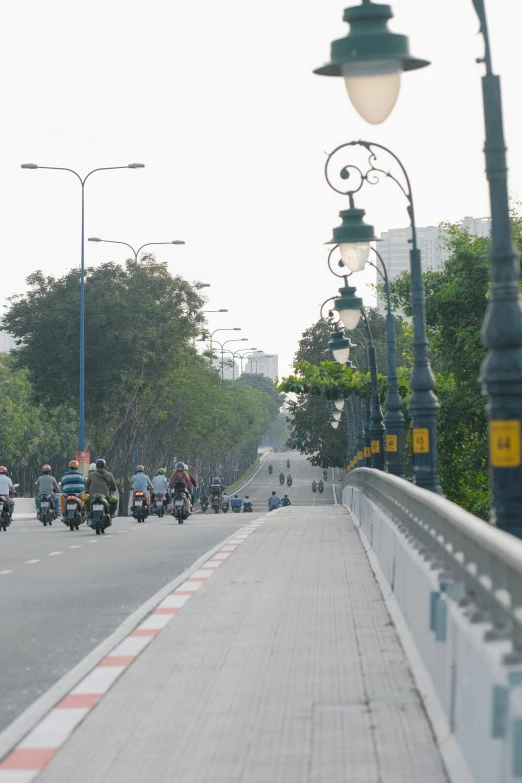 many people are on motorcycles riding down a road
