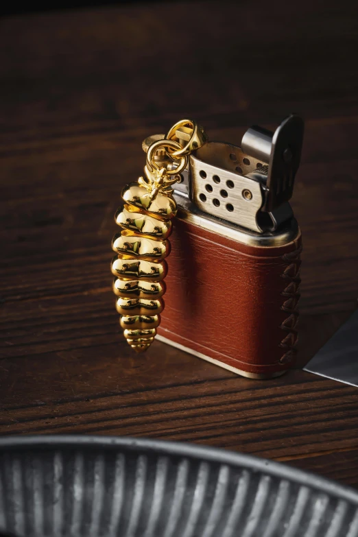 a lighter has been set on the table with a gold chain