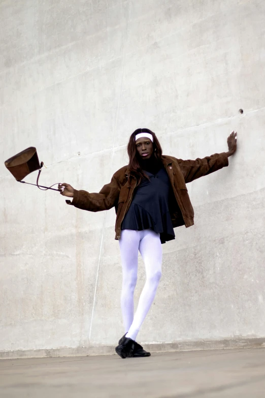 a woman is posing for a po while holding her arms in the air