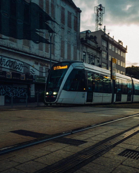 a train going down the tracks in an urban setting