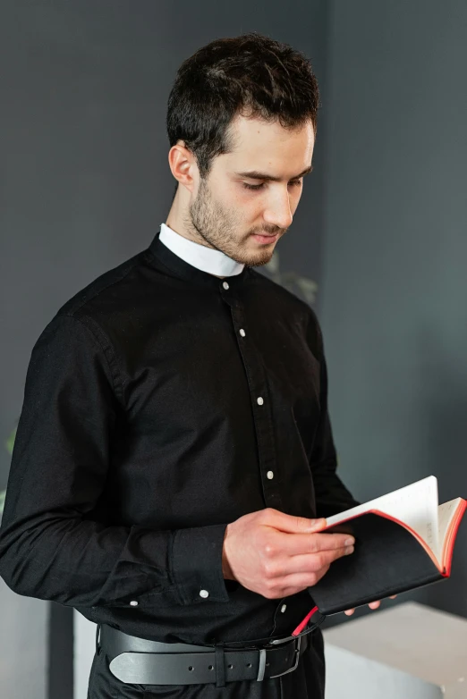 a man in priest robes holding a book