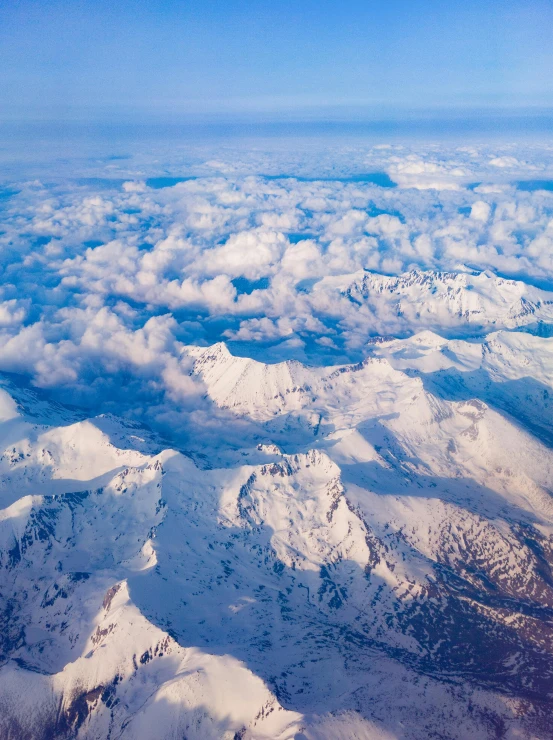 a mountain range surrounded by snow in the distance