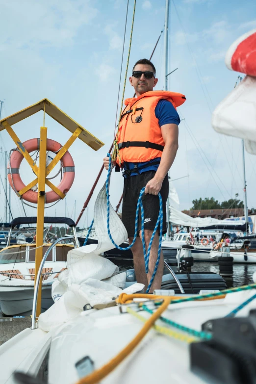 a man with life vest standing on boat