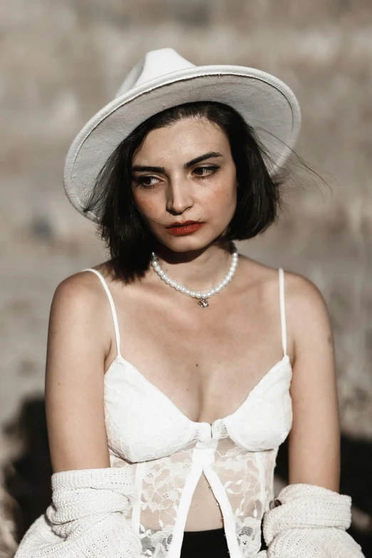 a woman wearing a let, a hat and gloves with red lips